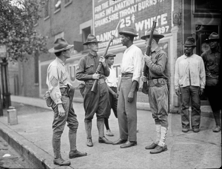 Armed National Guard and African American men standing on a sidewalk during the race riots in Chicago, 1919 (Courtesy of the Chicago History Museum)