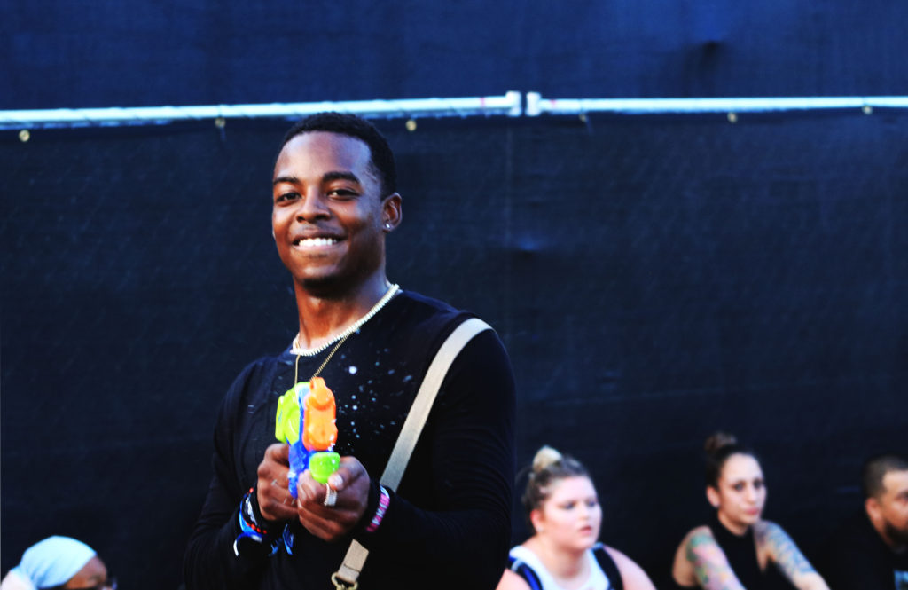 Festgoer playing with a water gun