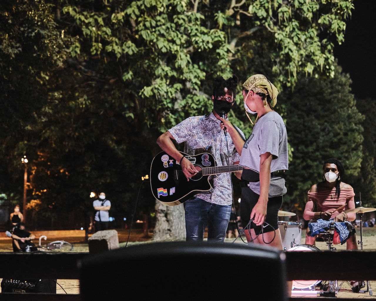 Protestor playing guitar at gathering