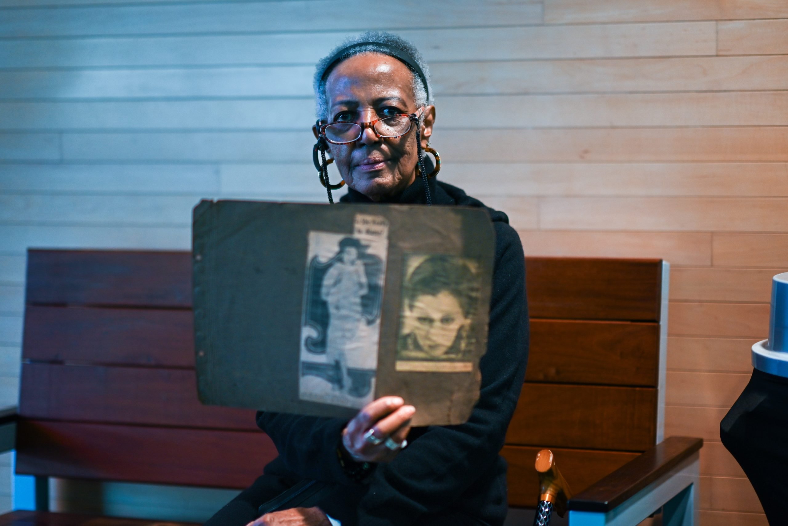 Kathleen Clark holds an artifact featuring an image of her mom Anna Jones.