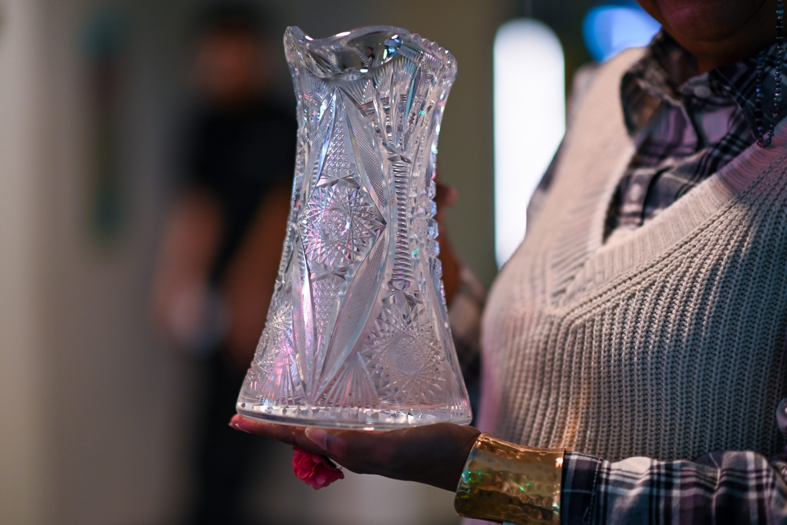 Close-up image of Bobbi Ball's crystal pitcher with two hands from her childhood.