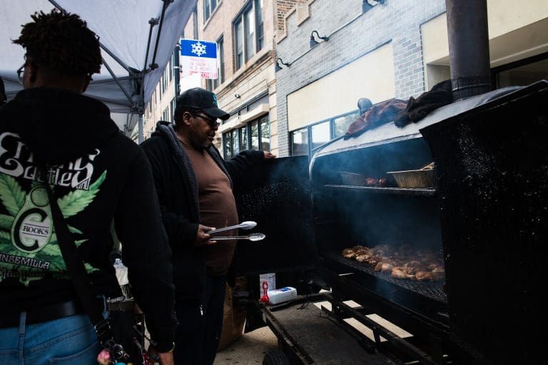 Food vendor grilling at "Spend In The Black" street fest on 75th and King Dr. on April 19, 2025. Photo by Ash Lane for The TRiiBE®