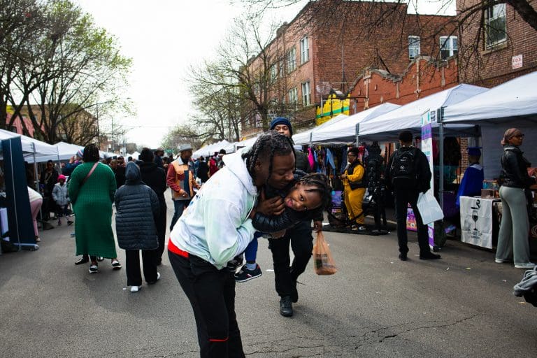 A family enjoying their time at "Spend In The Black" street fest. Photo by Ash Lane for The TRiiBE®