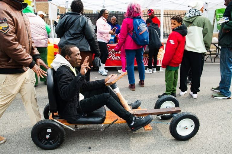 Resident cruising through the "Spend In The Black" street fest on 75th and King Dr. on April 19, 2025. Photo by Ash Lane for The TRiiBE®