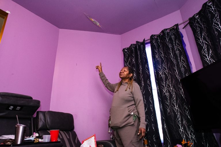 Shirley Anderson, a resident of North Lawndale, shows the flood damage in her living room, which occurred in July 2023, in her home. Photo by Ash Lane for The TRiiBE®