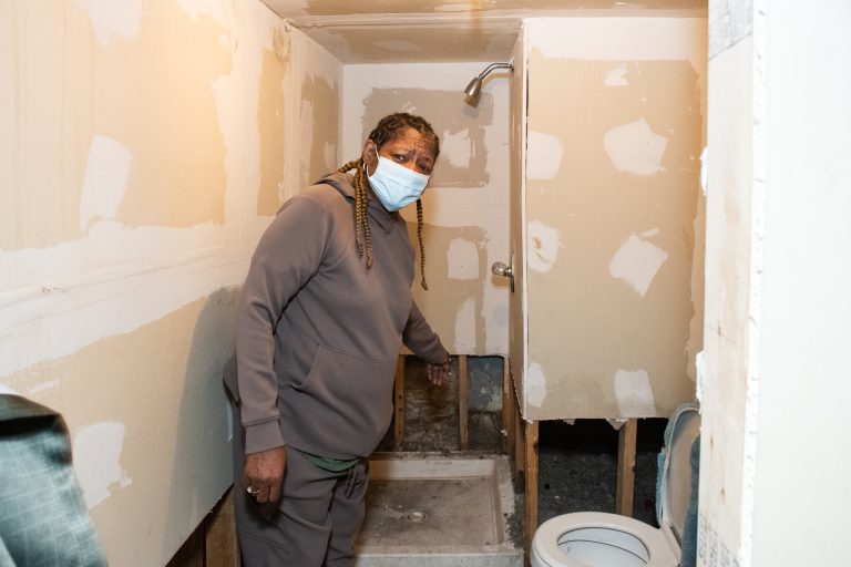 Shirley Anderson, a resident of North Lawndale, had part of the wall removed from a bathroom being installed in her basement due to a flood in July 2023. Photo by Ash Lane for The TRiiBE®