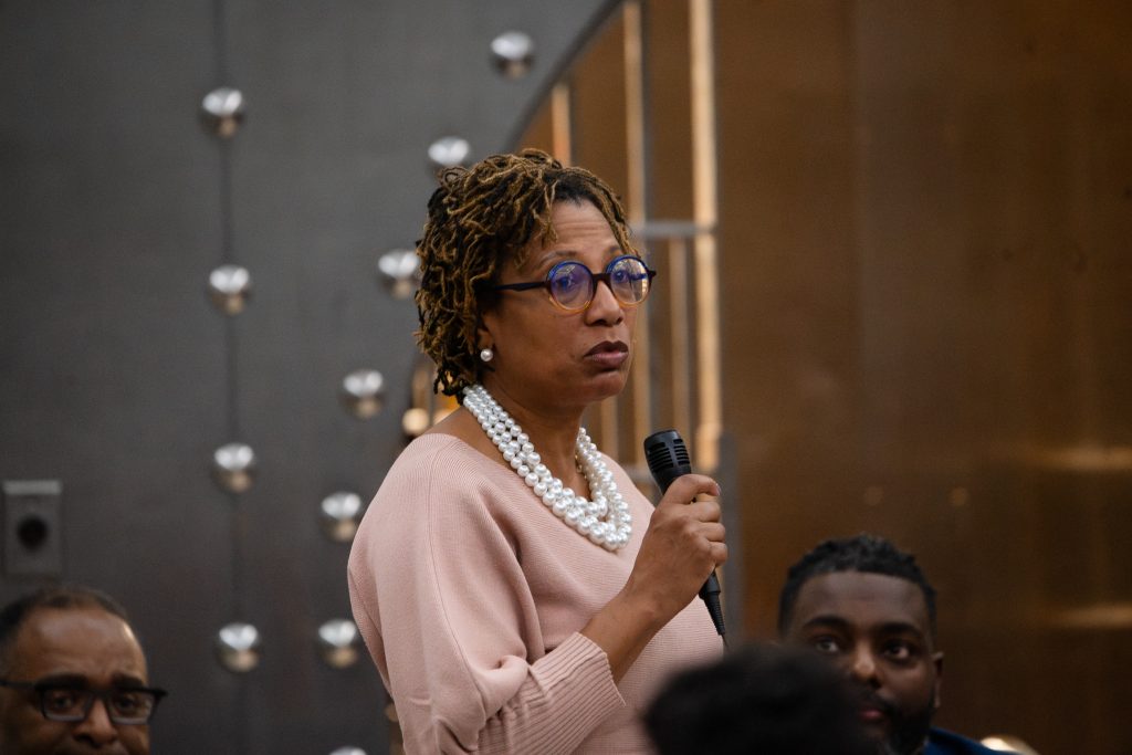 Westside Justice Center executive director Tanya Woods moderated the Chicago Black Voter Project's IL 07 candidate's forum. Photo by Ash Lane for The TRiiBE.