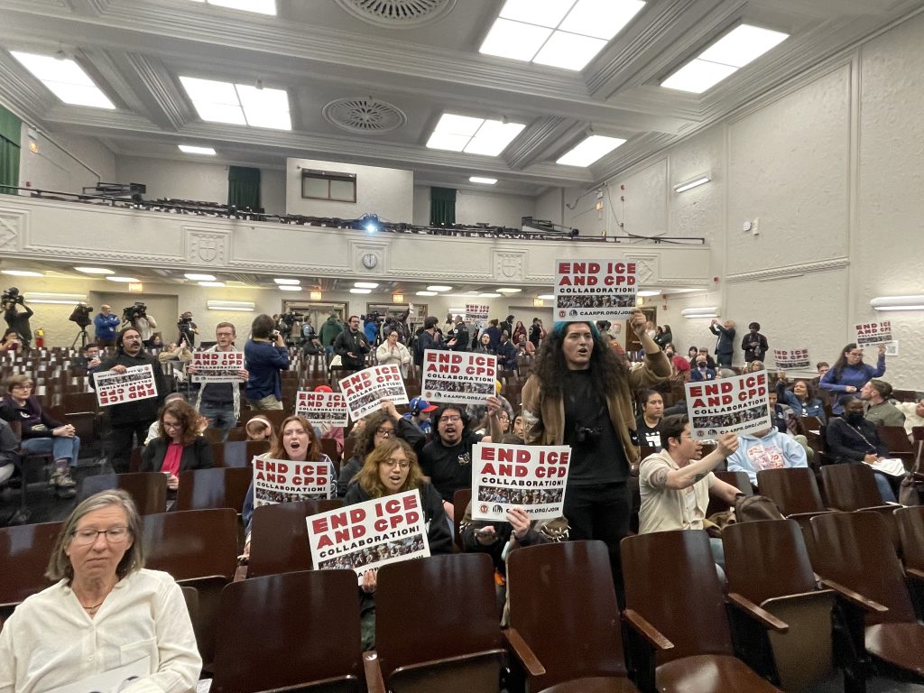 Protestors chanted “CPD, KKK, ICE, they’re all the same,” and held up signs with “End ICE and CPD collaboration," during an April 2, 2026, CCPSA meeting at Kelly High School.