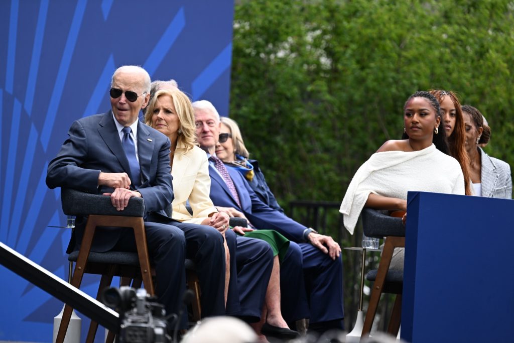 Former President Joe Biden and former First Lady Jill Biden, along with the Clintons and Malia and Sasha Obama looks on as Jennifer Hudson sings at the Obama Presidential Center's grand opening ceremony on June 18, 2026. Photo by Alexander Gouletas for The TRiiBE©