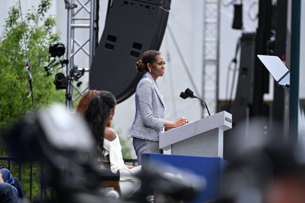 Former First Lady Michelle Obama takes the podium at the Obama Presidential Center's grand opening ceremony on June 18. 2026. Photo by Alexander Gouletas for The TRiiBE©